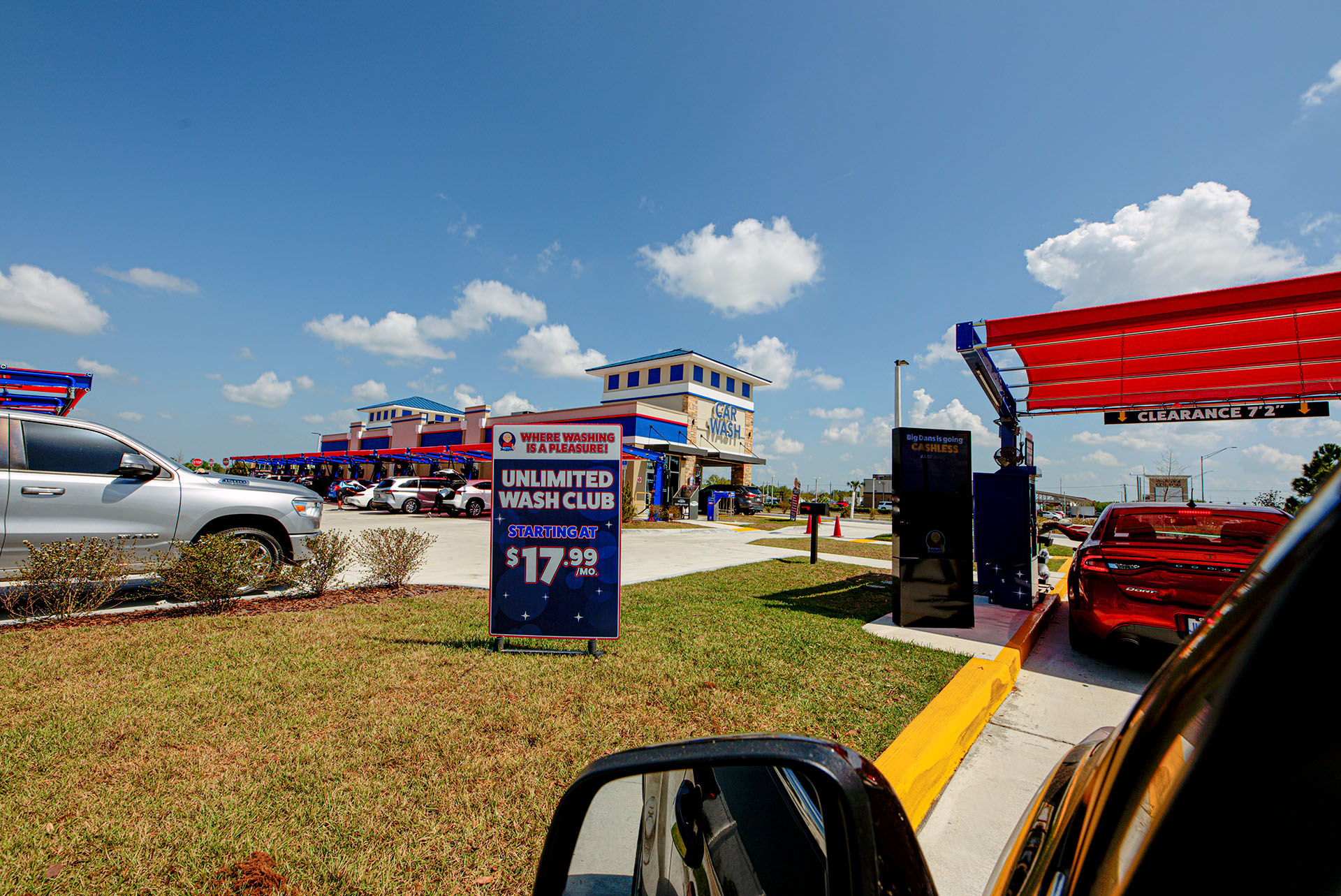 Driver's seat view of the line for Big Dan's soft-touch automatic car wash in Lakewood Ranch, FL