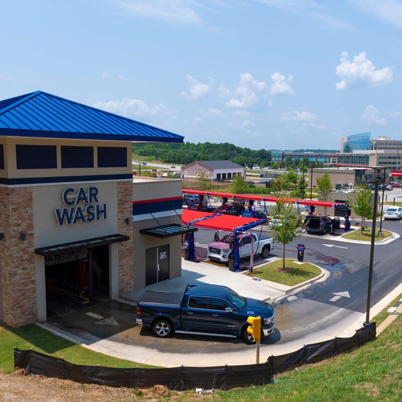 Exterior view of Big Dan's Car Wash lot in Hiram, GA, featuring its soft-touch automatic car wash and self-service areas