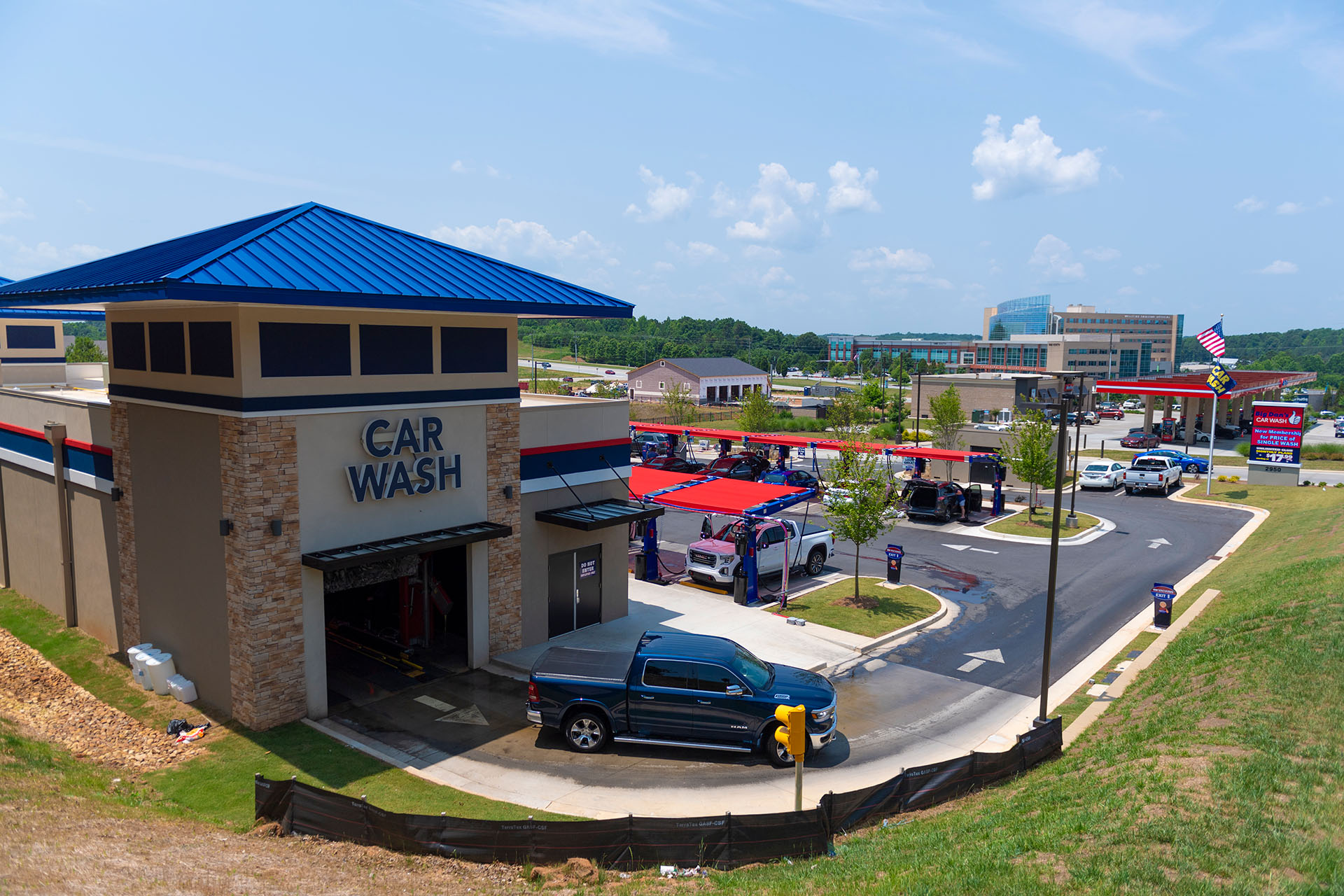 Exterior view of Big Dan's Car Wash lot in Hiram, GA, featuring its soft-touch automatic car wash and self-service areas