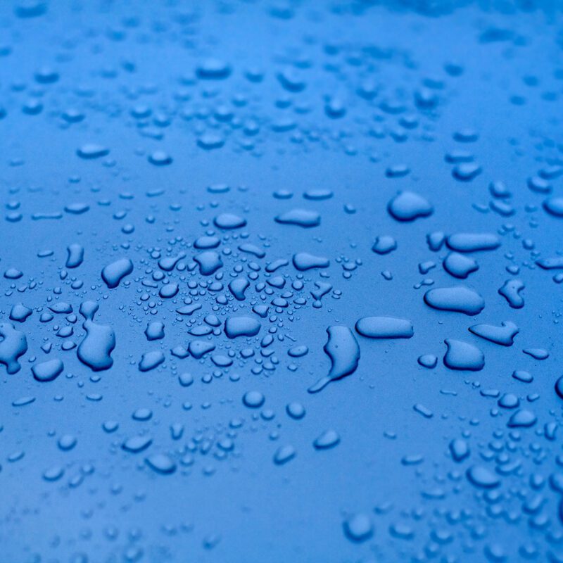 Water droplets on a bright blue background